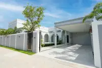 4 Bedroom House for Sale in Nong Prue white exterior front view with gated entrance and covered carport