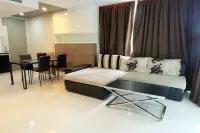3 Bedroom Condo for Sale at Apus living room with L-shaped sofa, glass coffee table, and dining set with dark curtains
