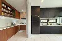 5 Bedroom House for Sale at The Lake Huay Yai dual kitchen with wood cabinets, black matte units, marble countertops, and marble tile floors