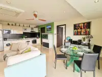 1 Bedroom Condo for Sale at The Park Jomtien open-plan living and dining area with kitchen and aquarium