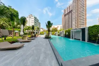 Arcadia Center Suite poolside deck with loungers, umbrellas, and city skyline backdrop