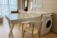 1 Bedroom Condo for Sale at Cetus Beachfront dining table with chairs and washing machine beside sea-view window