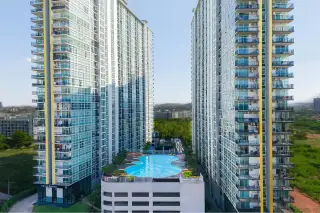 The Twin Tower Jomtien Beach Pattaya aerial view of outdoor rooftop swimming pool nestled between two glass-balcony condo towers