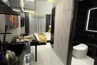 Studio Condo for Sale at Grand Solaire Noble: Kitchenette and dining area looking towards the bedroom and adjacent bathroom.