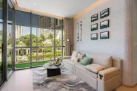 2 Bedroom Condo for Sale at Once Wong Amat bright living room with floor-to-ceiling windows overlooking palm trees and city