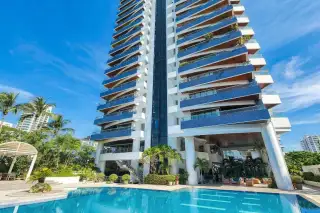 Baan Haad Uthong Condominium modern high-rise building exterior with blue balconies and glass facade.