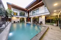 6 Bedroom House for Sale at M Mountain Village large private pool with water jets, palm tree, and illuminated two-storey villa facade