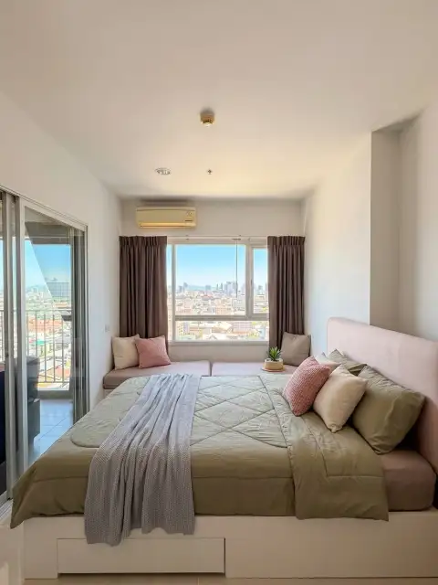 1 Bedroom Condo for Sale at Centric Sea bedroom with window seat and panoramic city skyline view
