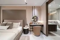 1 Bedroom Condo for Sale at Panora Estuaria: Contemporary kitchen with dark cabinetry, integrated appliances, and dining bar.