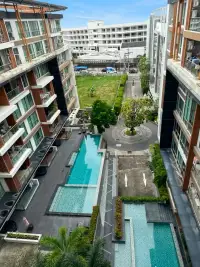 2 Bedroom Condo for Sale at The Urban Pattaya aerial view of swimming pools and landscaped courtyard between buildings