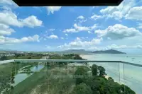 3 Bedroom Condo for Sale at Del Mare high-floor glass balcony overlooking turquoise sea, sandy beach, and mountain skyline