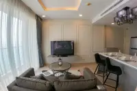 1 Bedroom Condo for Sale at Cetus Beachfront open-plan living room with sofa, TV wall, and breakfast bar seating