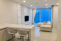 3 Bedroom Condo for Sale at Del Mare modern open-plan living and dining area with white bar stools and floor-to-ceiling windows