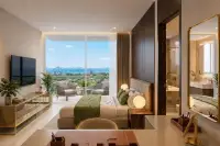 Studio Condo for Sale at Love It Wongamat Beach studio room with floor-to-ceiling windows, sea view balcony and ensuite bathroom