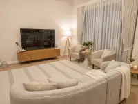 3 Bedroom House for Rent at Garden Ville 9 living area with TV console and armchairs by window
