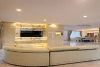 4 Bedroom House for Sale at Paradise Villa 1 & 2 open-plan living and dining area with marble TV feature wall and curved sofa