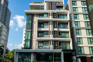 Sixty Six Condominium, aerial view of the modern building with a rooftop swimming pool and lounge area.