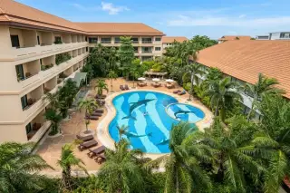 View Talay Residence 1&2 aerial view of freeform pool with dolphin mosaic tiles, sun loungers, and tropical gardens