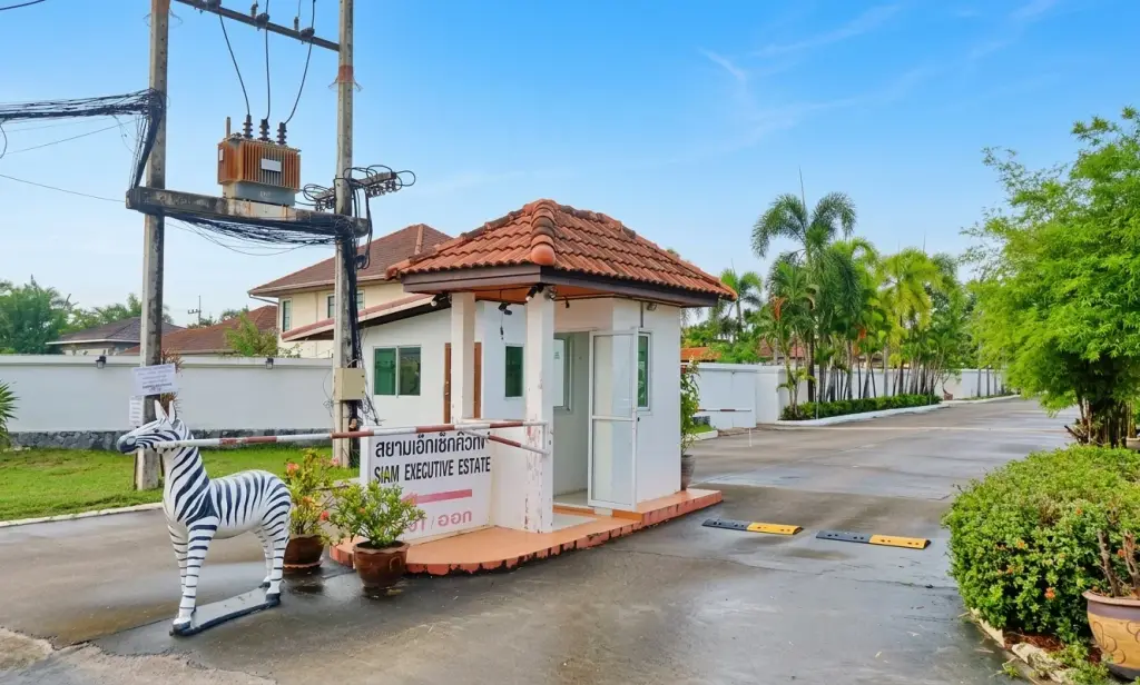Siam Executive Estate gated entrance with security booth and zebra statue in Pattaya