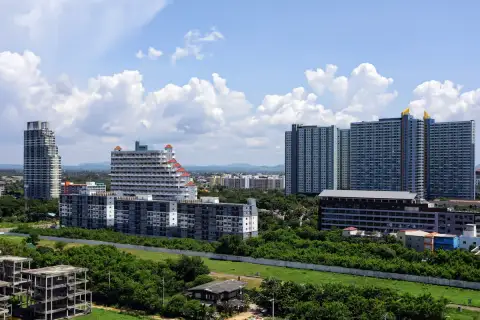 1 Bedroom Condo for Sale at Cetus Beachfront elevated city view showing Pattaya residential towers and lush greenery