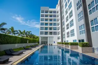Novana Residence exterior, showing the multi-story building facade with many windows and the property sign at the entrance.