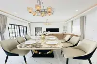 3 Bedroom House for Sale in Nong Prue elegant dining area with marble table gold chairs chandelier and open-plan living room