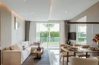 2 Bedroom Condo for Sale at The Coral Pattaya: modern living and dining area with garden view through large sliding doors.