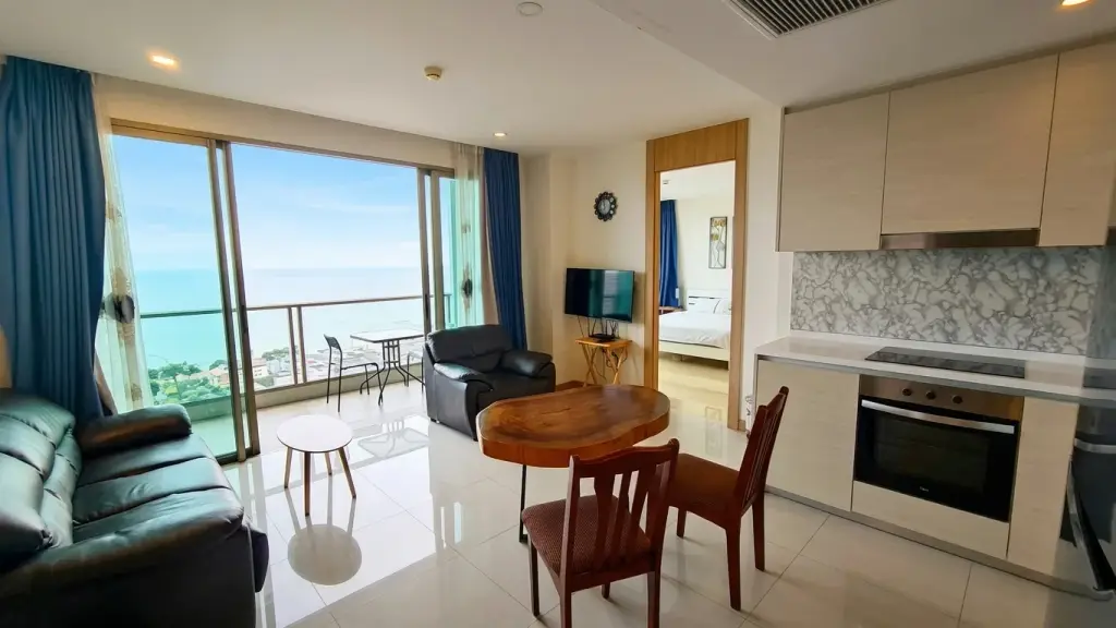 2 Bedroom Condo for Sale at The Riviera Jomtien living room with sea view balcony and open kitchen