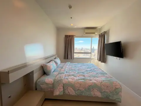 2 Bedroom Condo for Sale at Centric Sea bedroom with city skyline view and wall-mounted TV