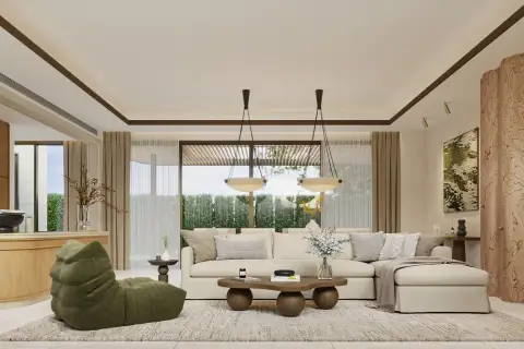4 Bedroom House for Sale at Solava Pattaya spacious living room with cream sectional sofa, green accent chair, and floor-to-ceiling windows