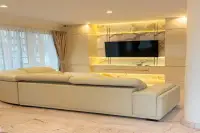 4 Bedroom House for Sale at Paradise Villa 1 & 2 spacious living room with cream leather sectional sofa and backlit marble TV wall