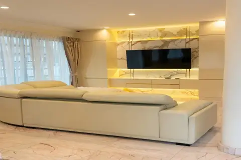 4 Bedroom House for Sale at Paradise Villa 1 & 2 spacious living room with cream leather sectional sofa and backlit marble TV wall