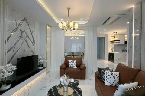 5 Bedroom House for Sale at Baan Suan Lalana, elegant living room with brown seating and view to dining area.