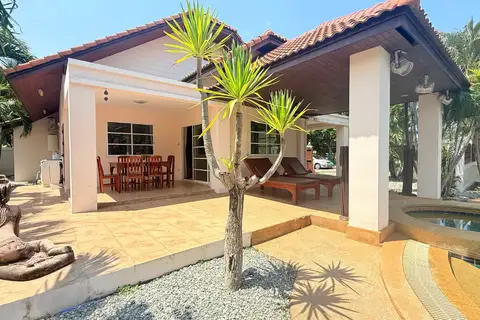 3 Bedroom House for Sale at Mike Orchid Villas 2, side exterior with covered patio, outdoor dining, and sun loungers.