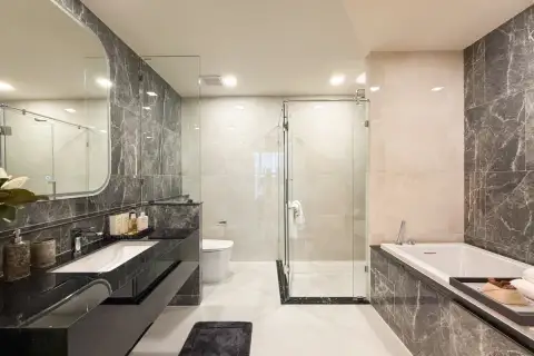 2 Bedroom Condo for Sale at Aquarous Jomtien Pattaya open-plan hallway with curved wood partition, floor-to-ceiling curtains, and bedroom view