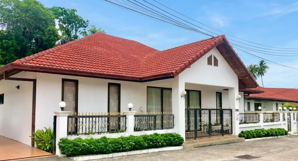 Regent Village 2 single-story house with red tiled roof, covered patio, and private swimming pool
