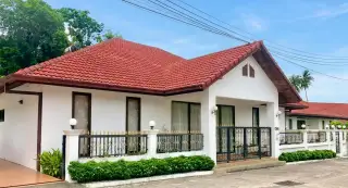 Regent Village 2 single-story house with red tiled roof, covered patio, and private swimming pool