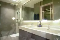 2 Bedroom Condo for Sale at SKYPARK Lucean Jomtien Pattaya modern bathroom with double vanity sinks, glass shower and backlit mirror