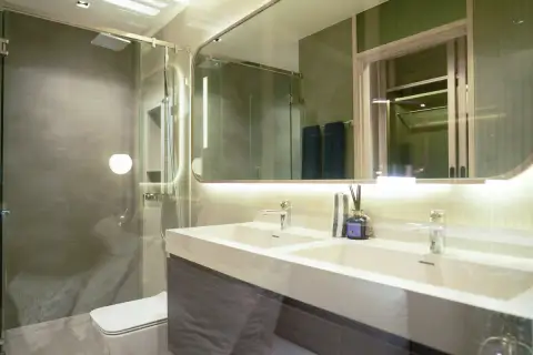 2 Bedroom Condo for Sale at SKYPARK Lucean Jomtien Pattaya modern bathroom with double vanity sinks, glass shower and backlit mirror