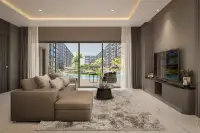 3 Bedroom Condo for Sale at Zenith 2 living room with sectional sofa and pool view through glass doors