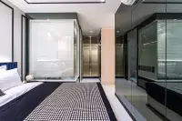 2 Bedroom Condo for Sale at Embassy Life master bedroom showing glass bathroom partition, mirrored wardrobe and double bed