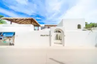 4 Bedroom House for Sale at The Sunshine House white-render exterior entrance gate with House No.1 sign and arched doorway with cacti