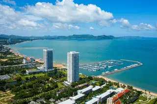 Ocean Portofino aerial view of twin condo towers beside marina and sandy beach in Pattaya Thailand