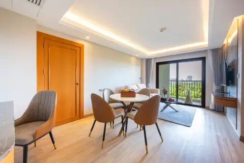 2 Bedroom Condo for Sale at Wyndham Jomtien Pattaya - bedroom with two beds, blue pillows, and large window.