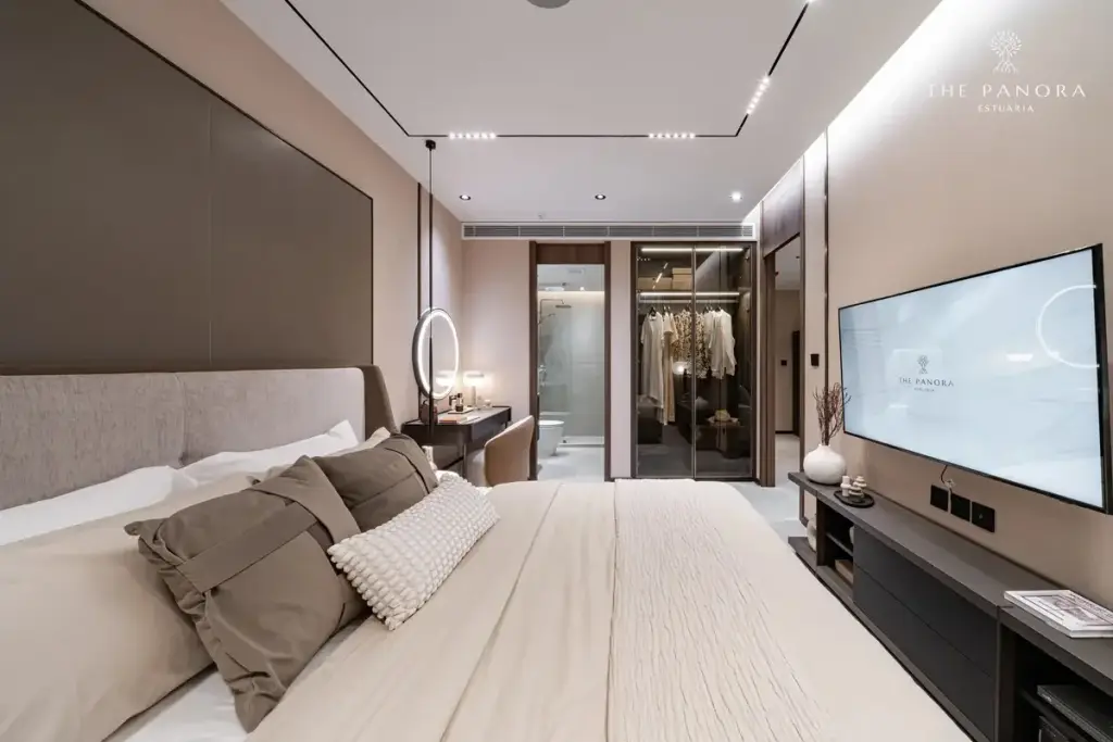 1 Bedroom Condo for Sale at Panora Estuaria: Open-plan living room with beige sofa, coffee table, and kitchen bar.