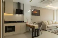 1 Bedroom Condo for Sale at Zensiri Estates and Residences modern kitchen with black marble countertop, built-in oven, and dining table