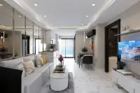 2 Bedroom Condo for Sale at Grand Solaire Noble bedroom with large wall-mounted TV and night city view window