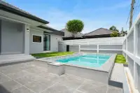 3 Bedroom House for Sale at Phonthep Garden Ville 2 private pool with tiled terrace and green lawn in walled backyard