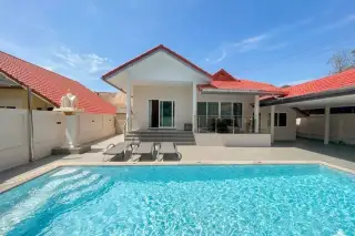 Royal Prestige house exterior with private swimming pool, sun loungers, and red tiled roof