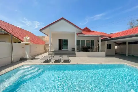 Royal Prestige house exterior with private swimming pool, sun loungers, and red tiled roof